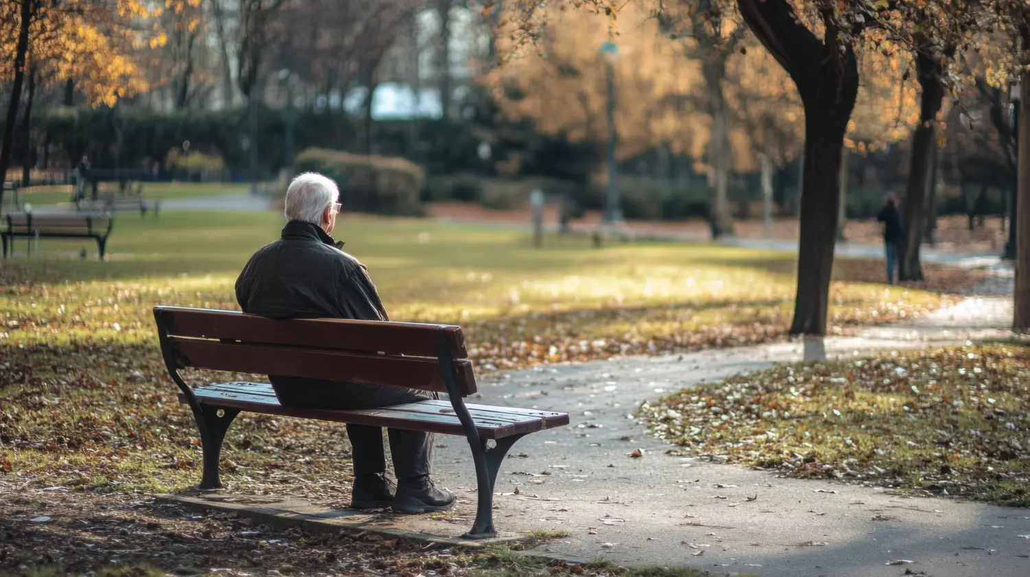 Eine isolierte ältere Person, die auf einer Parkbank sitzt und über die Einsamkeit und Isolation nachdenkt, mit der ältere Menschen konfrontiert sind, minimalistischer Stil